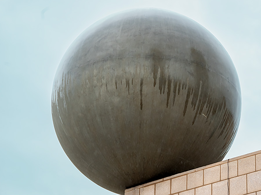 Large ball sculpture on edge of roof