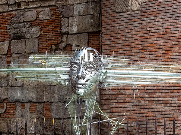 Bright metal surreal sculpture with head