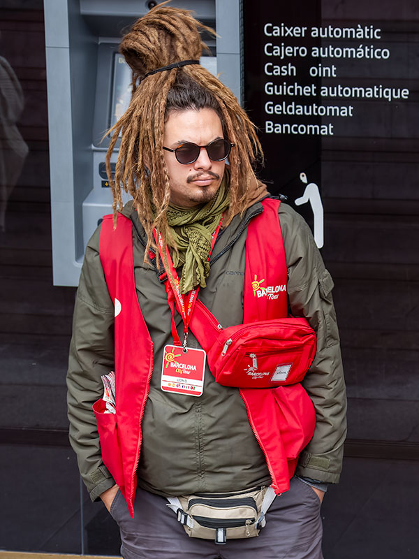 Man in red tourist jacket with dread locks waiting