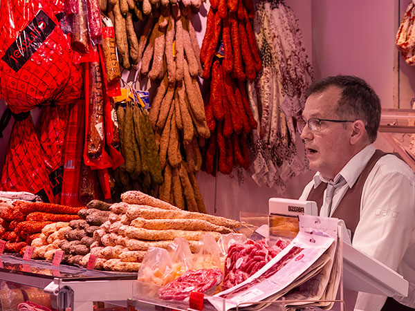 Sausage vendor in Barcelona marketplace