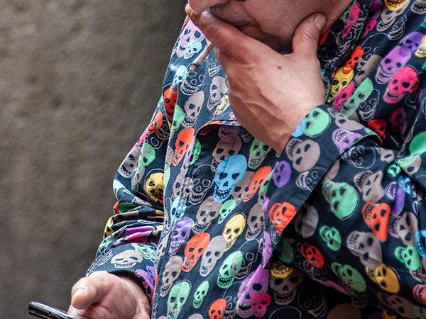 Smoker in colorful skull shirt