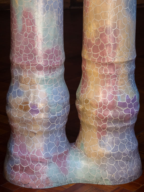 Two Unusual shaped, pastel colored columns joined at bottom inside Gaudi designed house in Barcelona