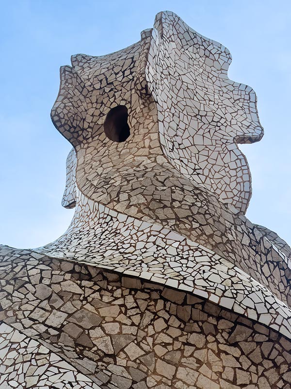 Unusual shaped sculpture on roof of Gaudi designed house in Barcelona.