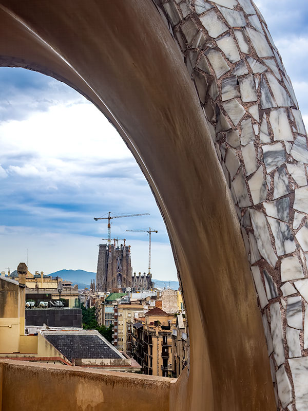 Sagrada Familia and Barcelona seen from roof of of Gaudi designed house in Barcelona.