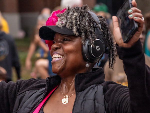 Racer with headphones and big smiling after race