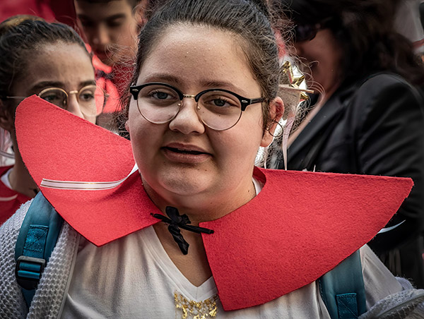 Young, costumed smiling girl in Naples Italy parade