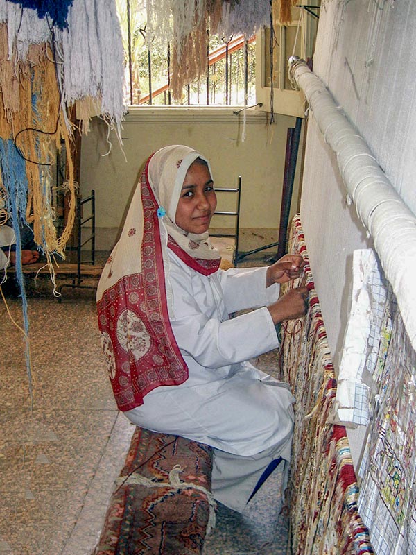 Egyptian rug weaver smiling
