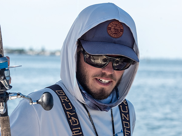 Hooded young fisherman smiling